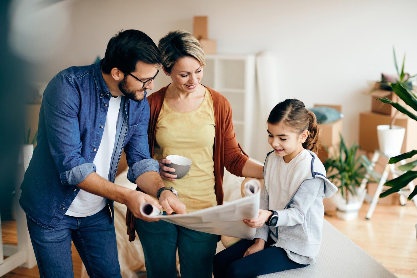 happy-family-going-through-housing-plans-while-moving-into-new-home_637285-12326